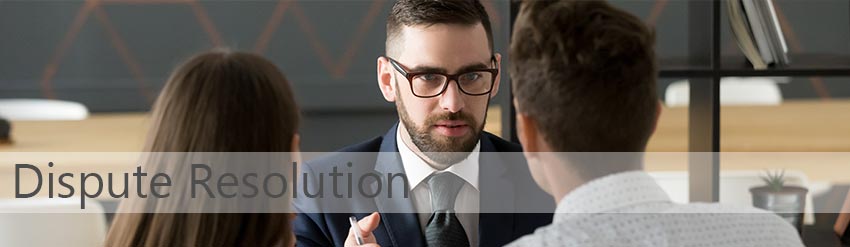 dispute resolution service offered by Blake Turner. Photo showing business people sat at a table resolving a dispute.