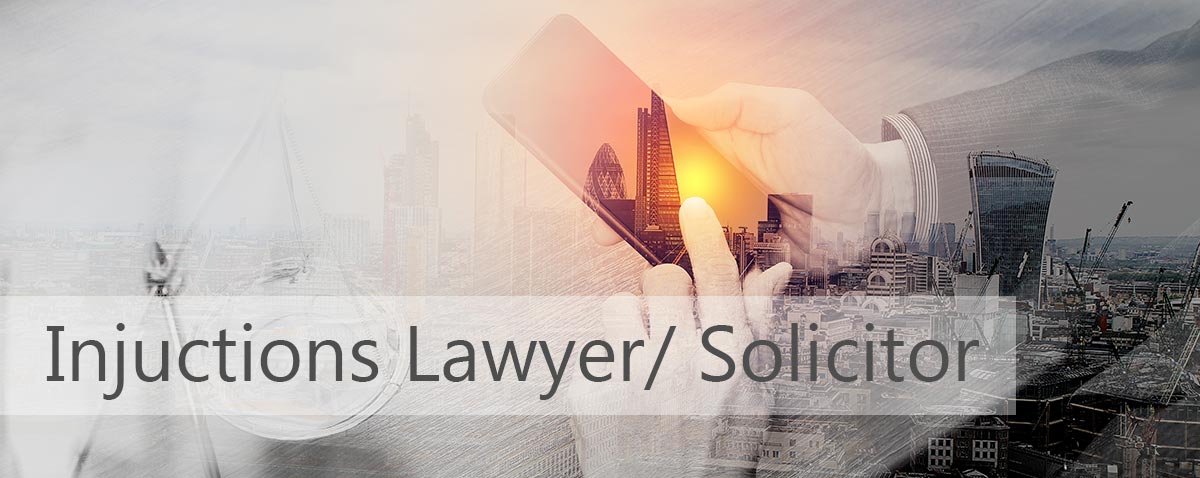 injunctions laywer and solicitor in london. photo of lawyer sat in an office in london.